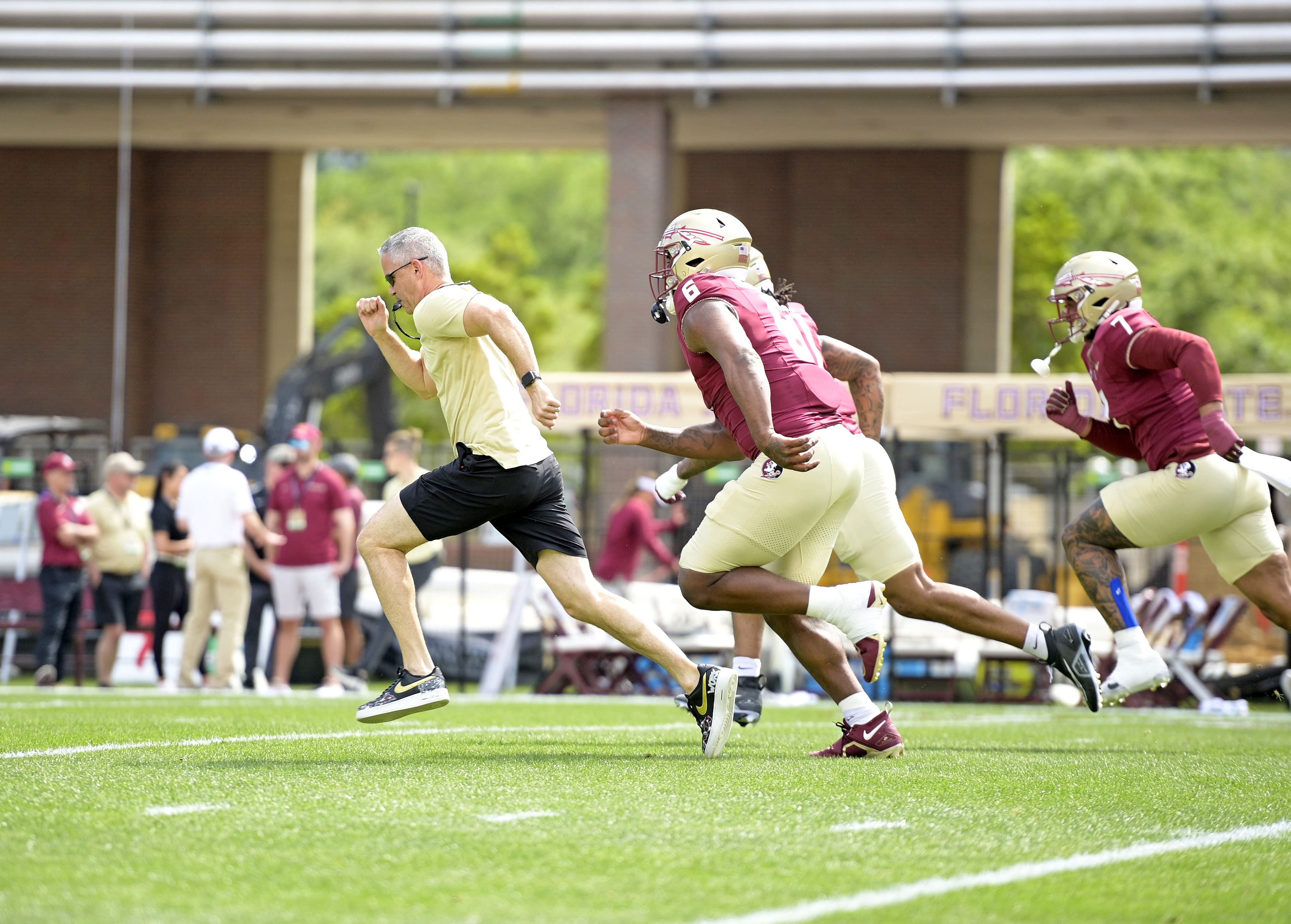 Florida State Seminoles head coach Mike Norvell races some of his players to the other end of the field during the Spring - Source: Imagn